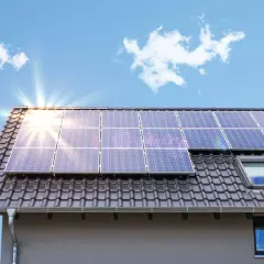 Solpaneler på ett tak. Även om solenergi är bra, finns det nackdelar med solenergi som kan påverka dess effektivitet, som molnighet.